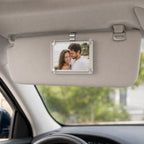 Looma CloseBy photo frame clipped to a car sun visor with a personal photo displayed.