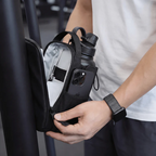 Person opening the magnetic gym bag to show its organizational pockets
