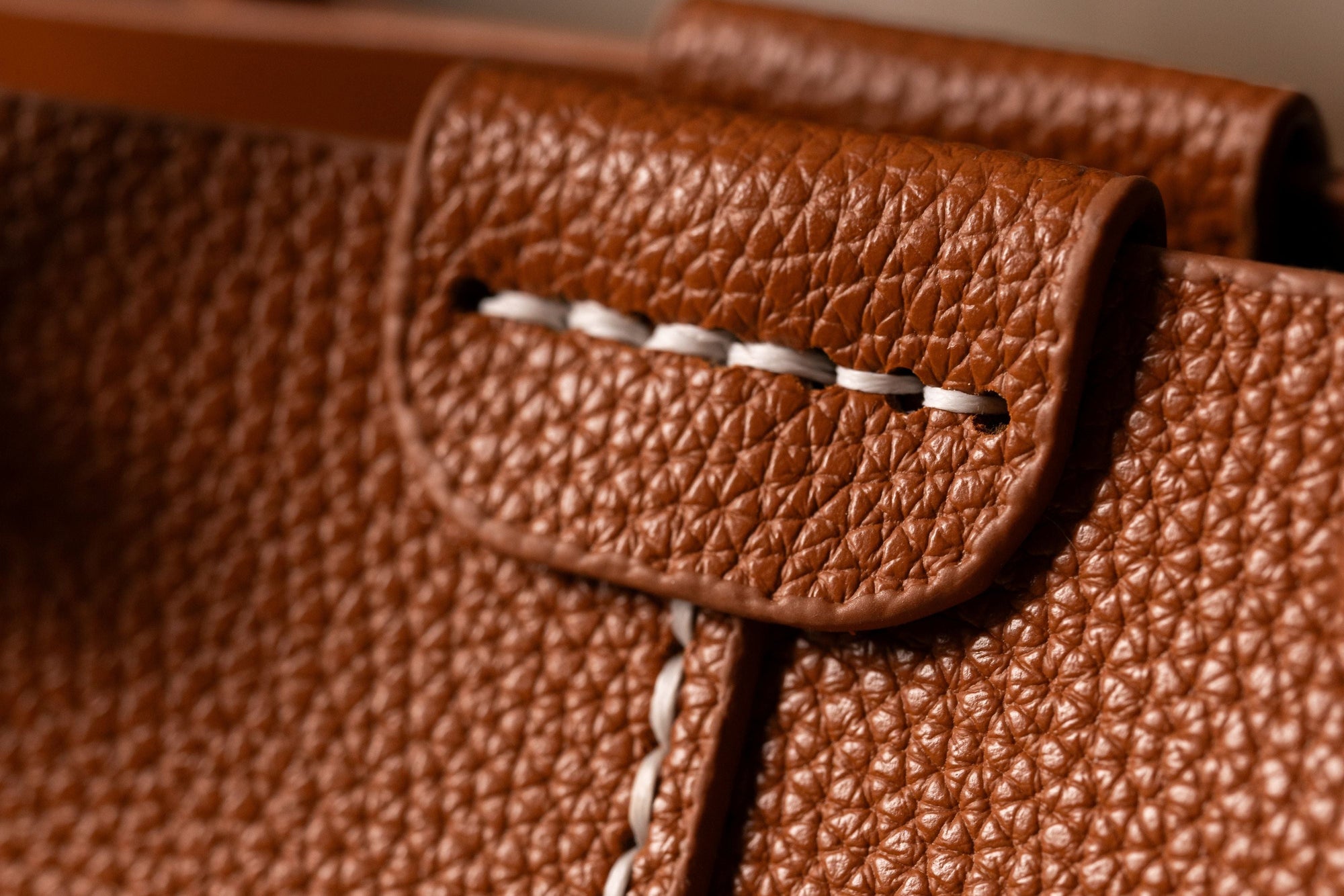 Close-up of stitched brown handbag material