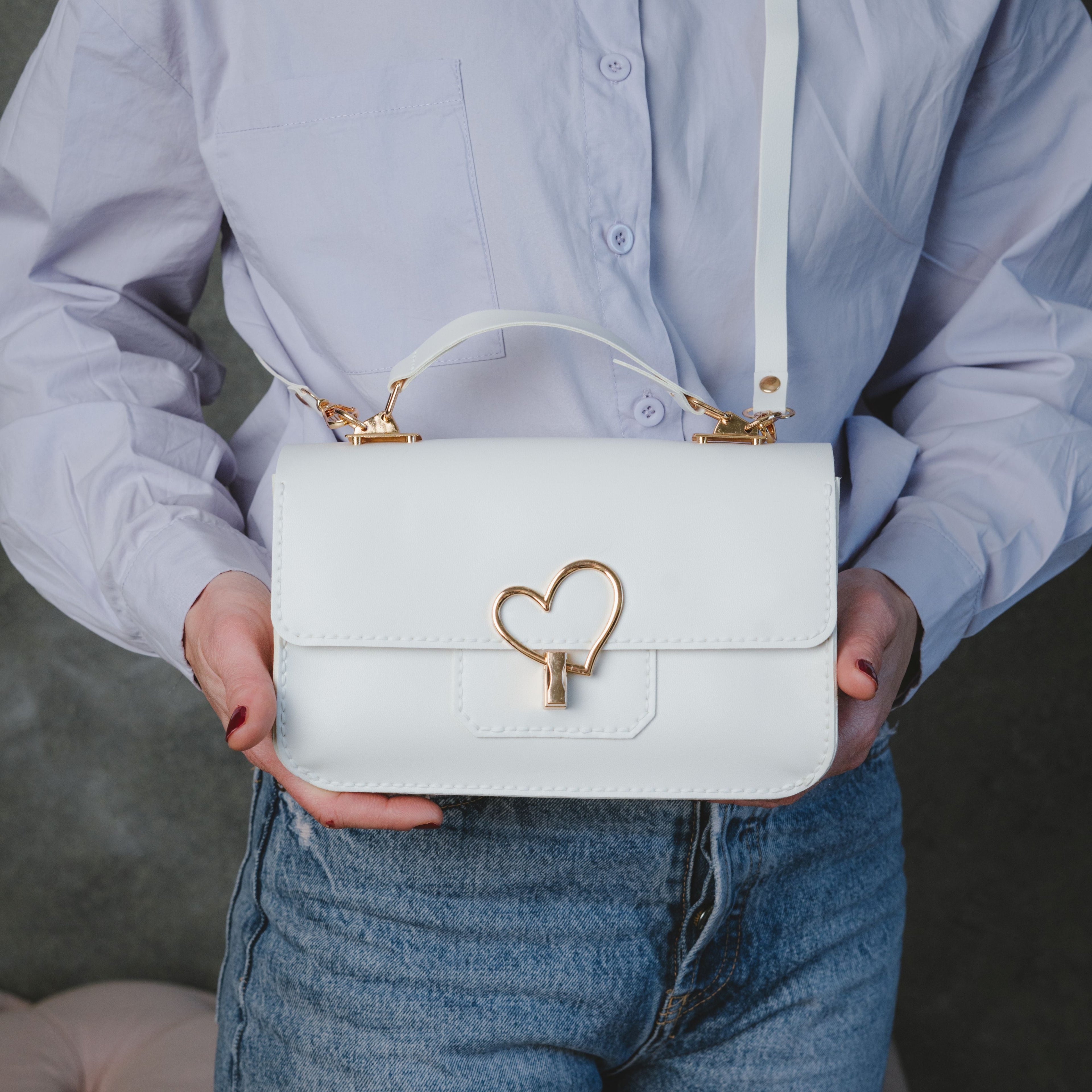 Moytsa White finished handbag held in front
