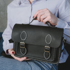 Liliora Black finished handbag held in front