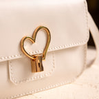 Moytsa White heart-shaped clasp and stitching detail