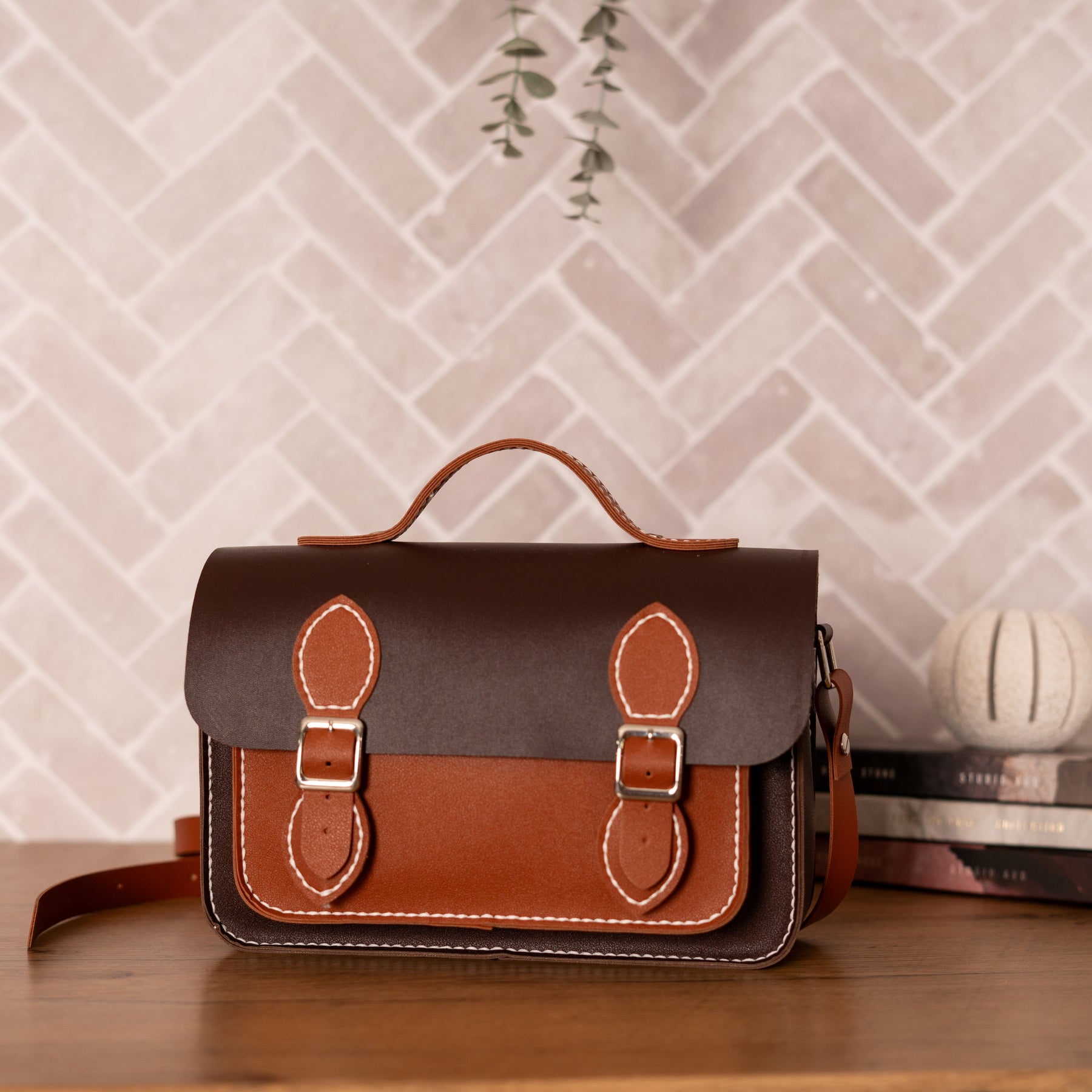 Finished brown Liliora handbag styled on a shelf
