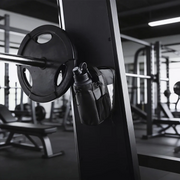Black magnetic gym bag attached beside a weight plate on compatible steel gym equipment