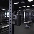 Black magnetic gym bag attached to a steel rack in a gym
